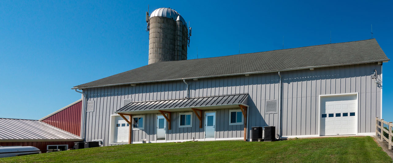 custom barn with a silo in the background